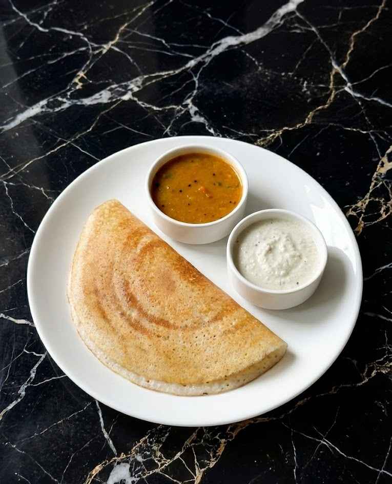 Crispy dosa served with sambar and coconut chutney on a white plate – crispy dosa recipe (தோசை).