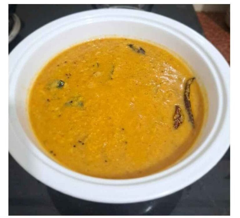 Tiffin Sambhar Hotel Style சாம்பார் served in a bowl with thick texture, curry leaves and roasted spices.
