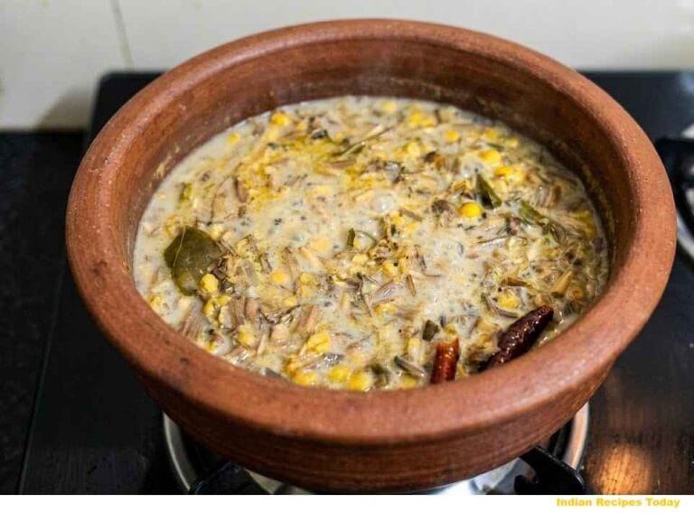 Final cooked Vazhaipoo Kootu (வாழைப்பூ கூட்டு) with banana flower and channa dal simmered in a clay pot with onions, red chillies and turmeric.