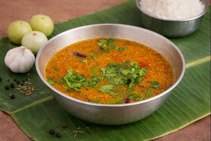 Nellikai Rasam (நெல்லிக்காய் ரசம்) served hot in a steel bowl on banana leaf – traditional South Indian amla rasam