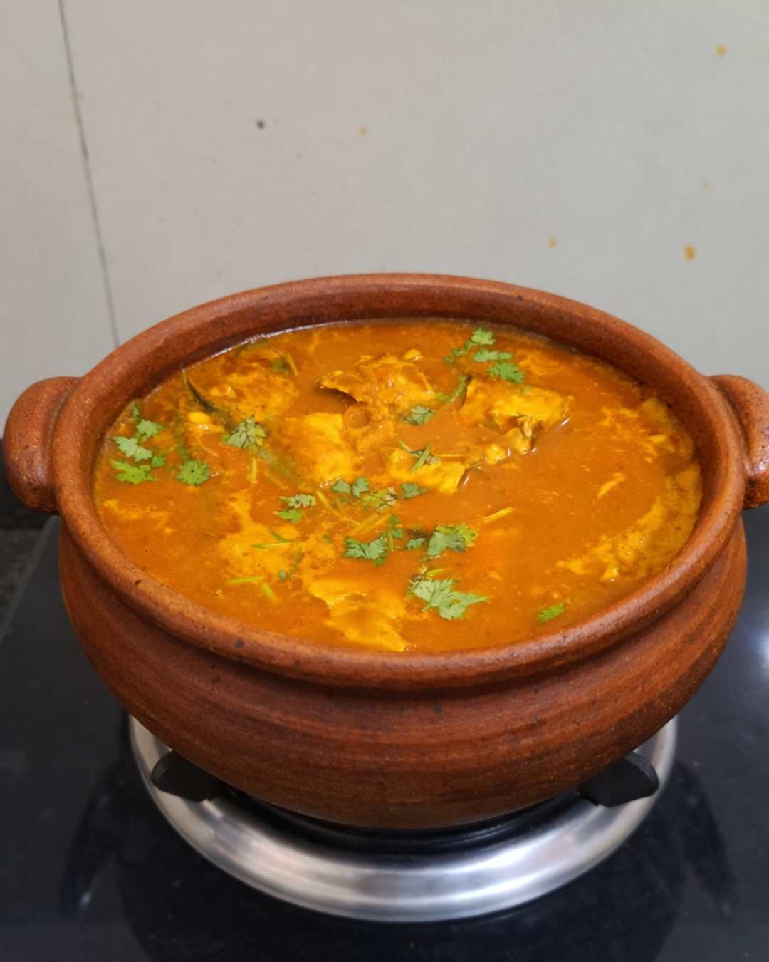 Ayila meen kulambu cooked in clay pot using fish head pieces, traditional South Indian fish curry