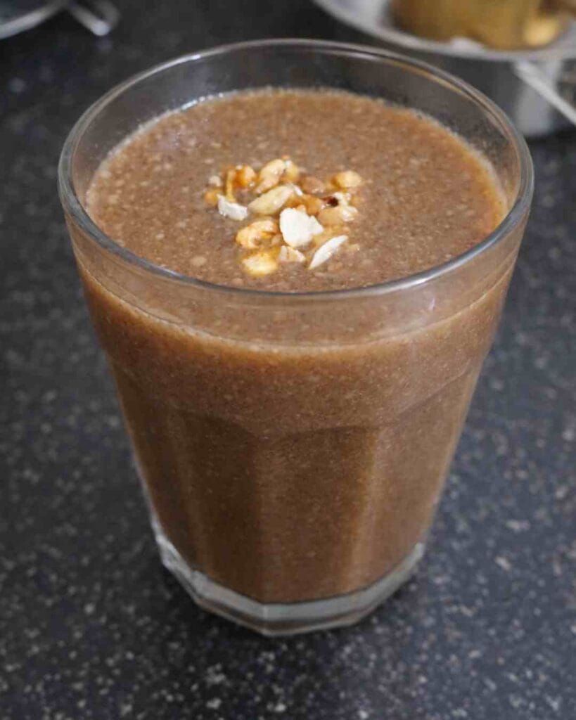 Ready karuppu ulundhu kanji served warm topped with nuts for a high protein breakfast