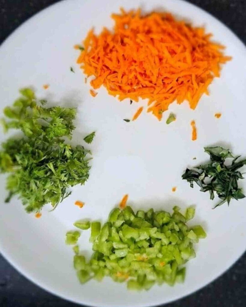 grated carrot, capsicum, coriander and curry leaves for kadalai maavu dosa