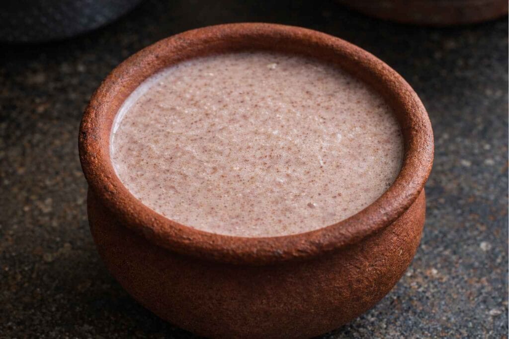 Plain fermented kezhvaragu koozh served in traditional clay pot