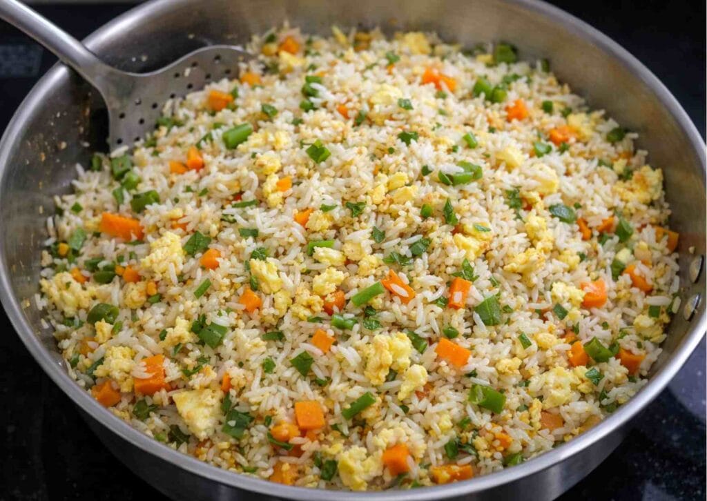 Quick egg fried rice with leftover rice garnished with chopped spring onion greens