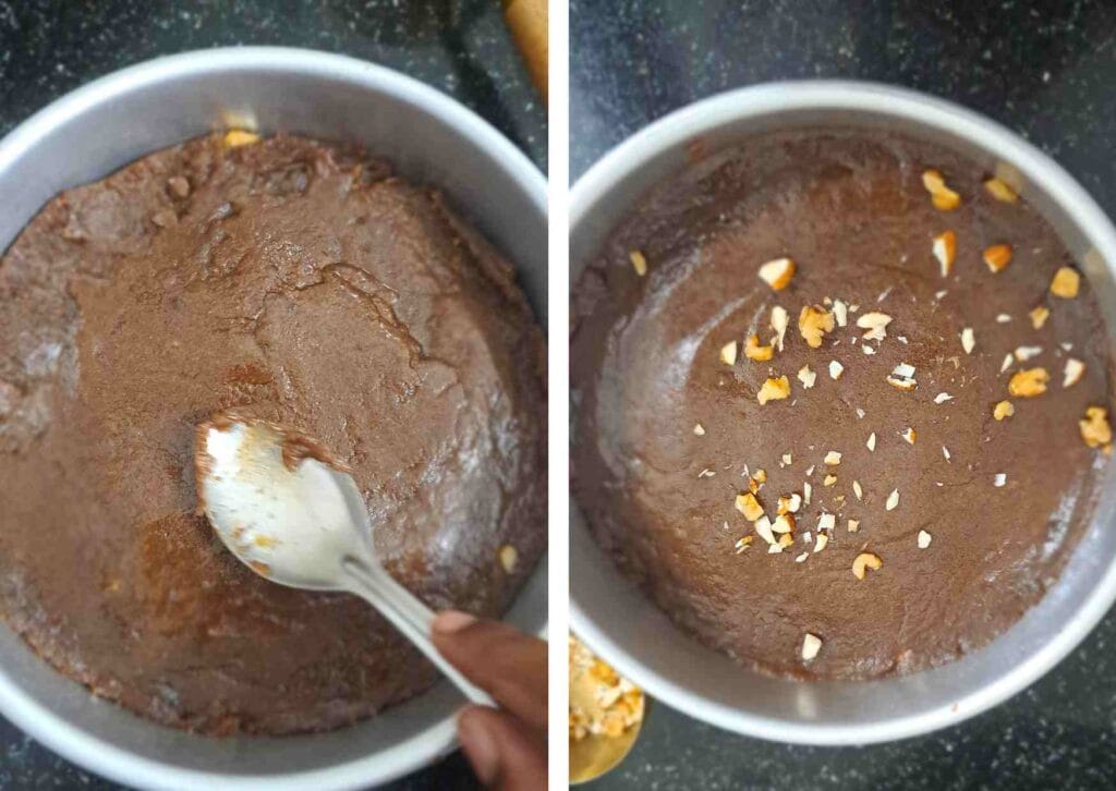 Spreading ragi burfi mixture evenly in tray with palm jaggery and nuts