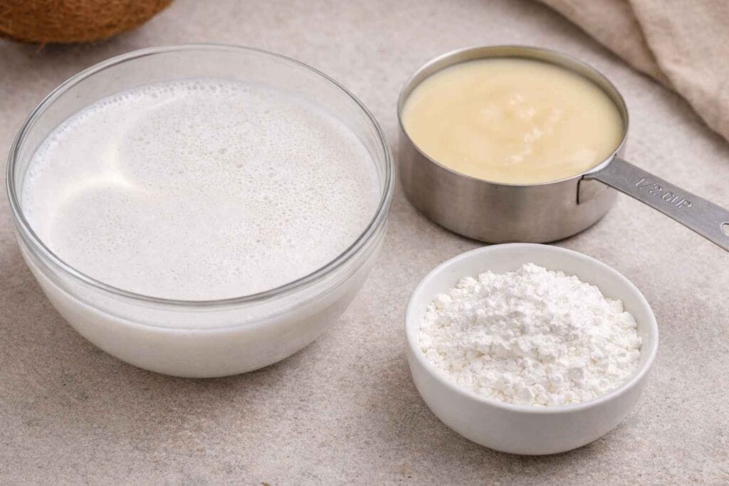 Coconut milk, condensed milk and corn flour used for making coconut pudding without lemon grass at home