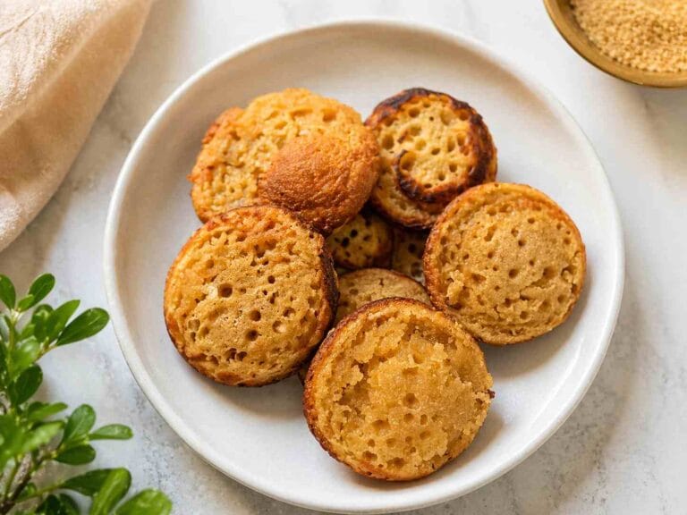 Easy sweet paniyaram recipe made with rava and jaggery, soft inside and crispy outside, served on a plate