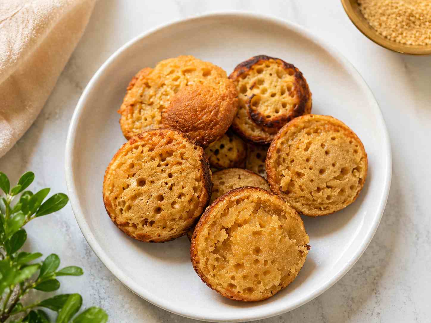 Easy sweet paniyaram recipe made with rava and jaggery, soft inside and crispy outside, served on a plate