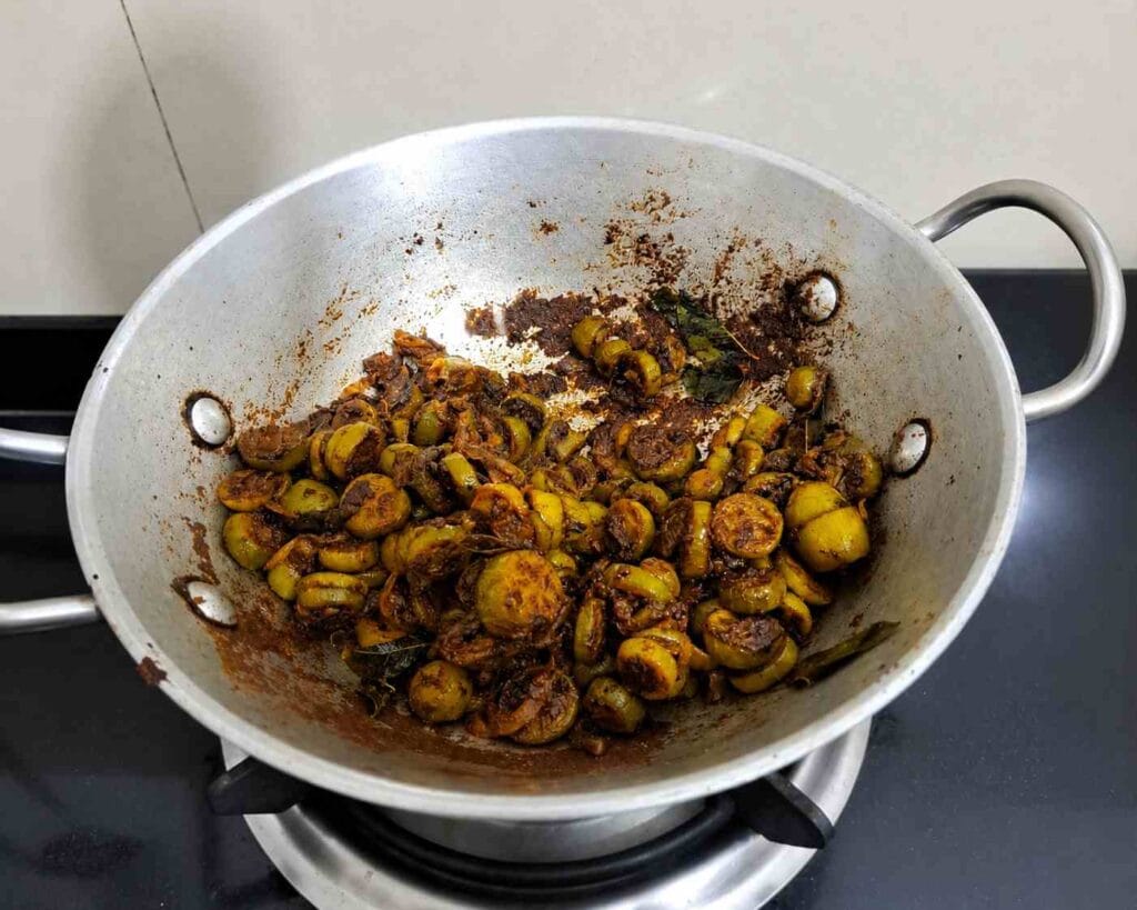 Crispy kovakkai varuval roasted in a kadai with onions, curry leaves, and South Indian spices