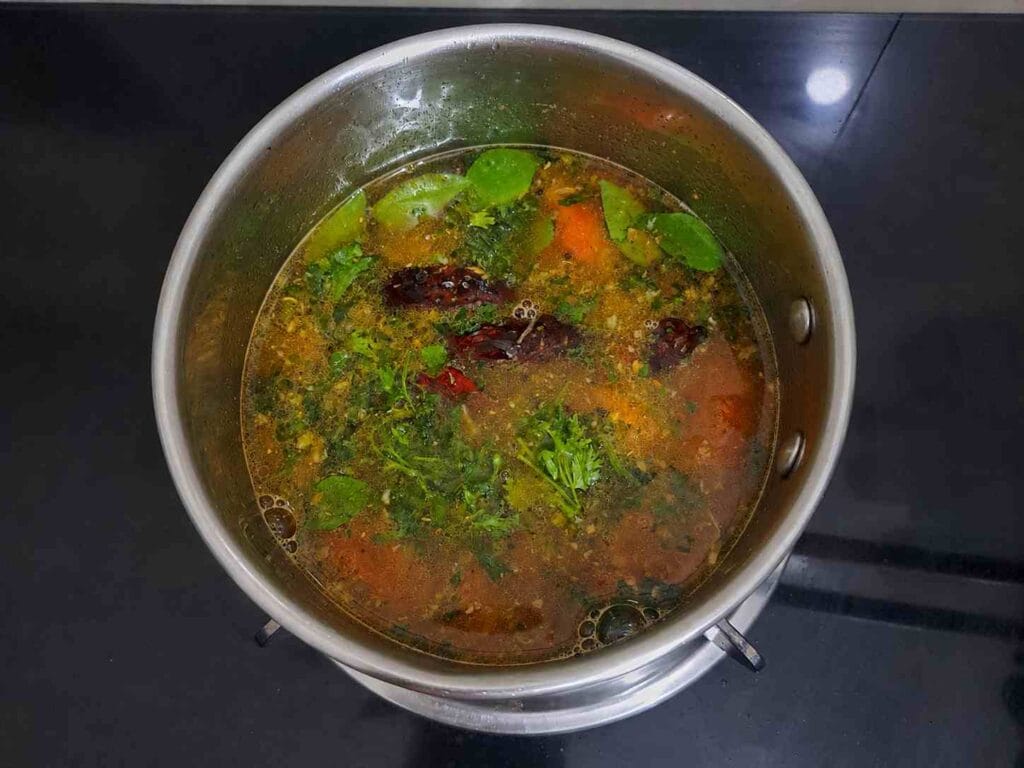 Homemade pepper garlic milagu rasam served hot in a pan