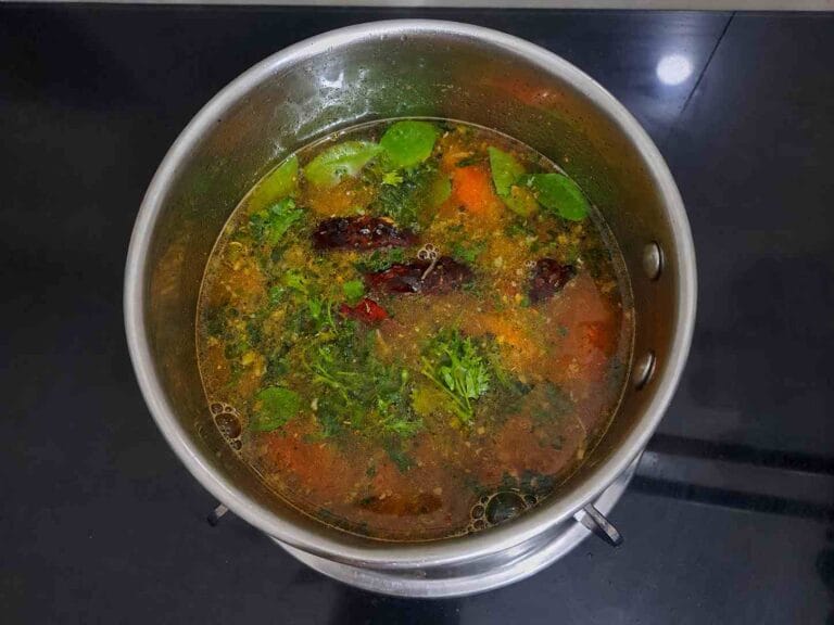 Homemade pepper garlic milagu rasam served hot in a pan