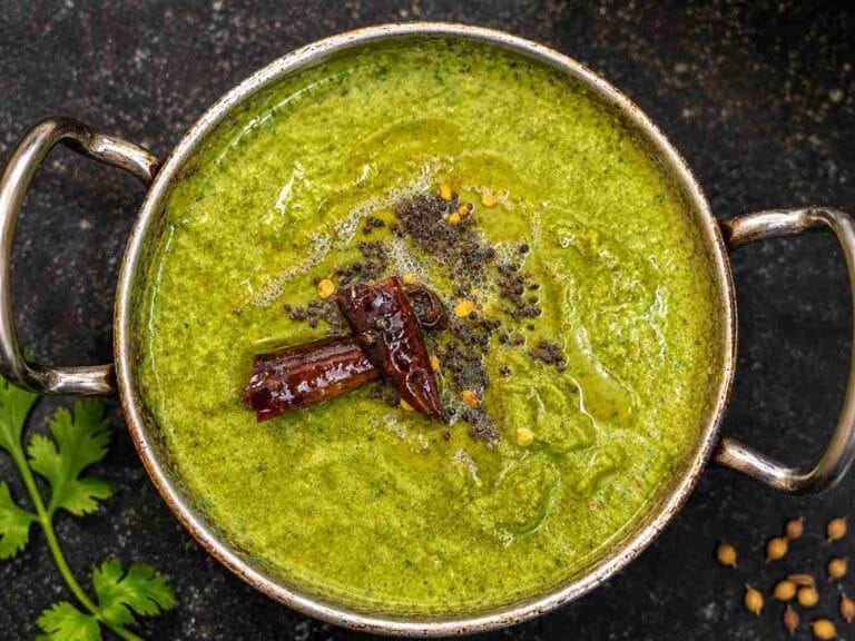 Homemade South Indian coriander chutney recipe served with mustard tempering in a traditional bowl