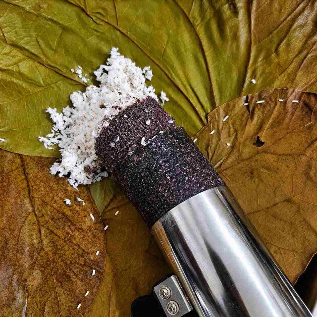 Healthy Kavuni Arisi Puttu served with coconut after steaming in a traditional South Indian puttu maker.