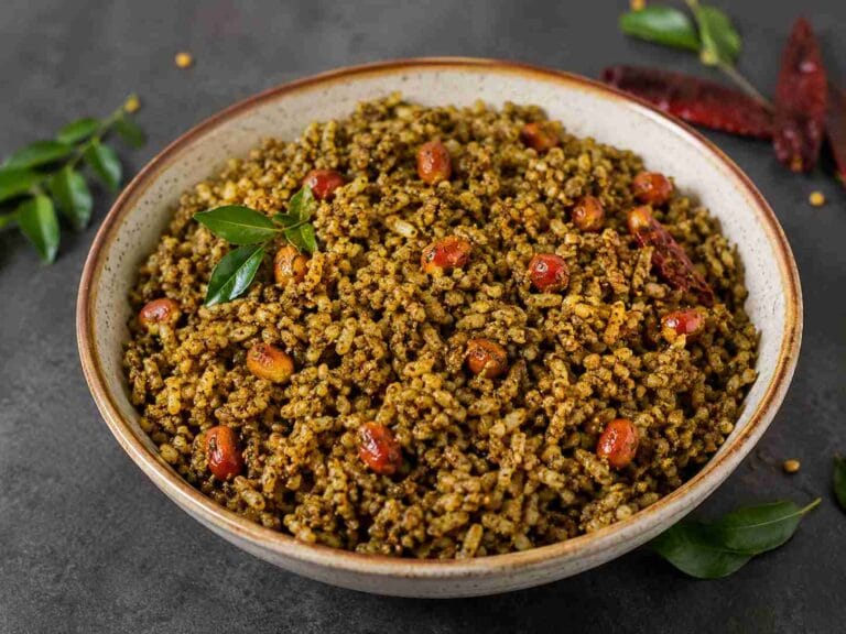 Karuveppilai Sadam served in a bowl with roasted peanuts and curry leaves, a traditional South Indian curry leaves rice recipe.