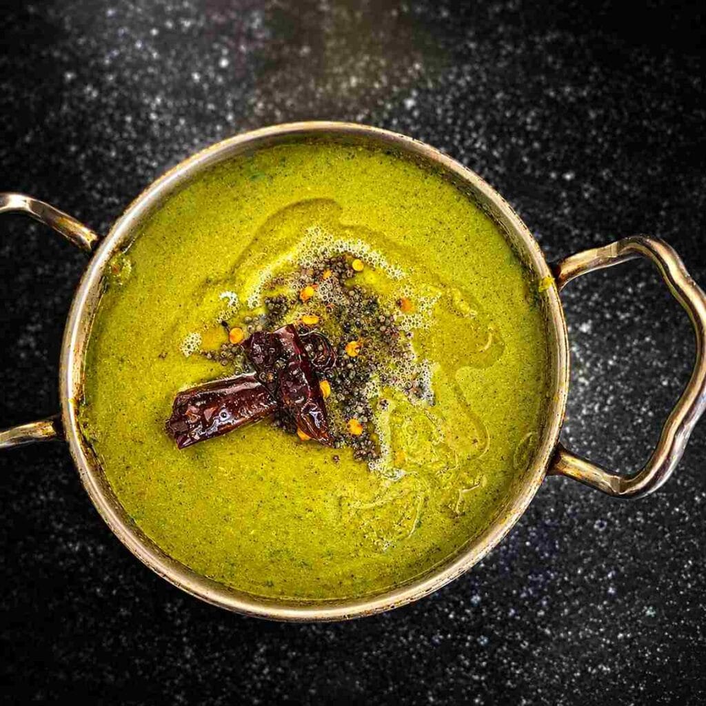 Homemade kothamalli chutney with mustard tempering served in a traditional bowl