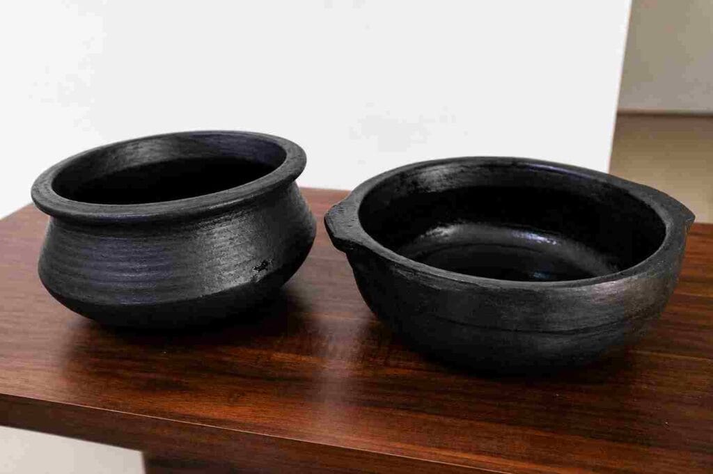 seasoned clay pots ready for cooking after preparation showing final condition of earthen cookware for everyday kitchen use