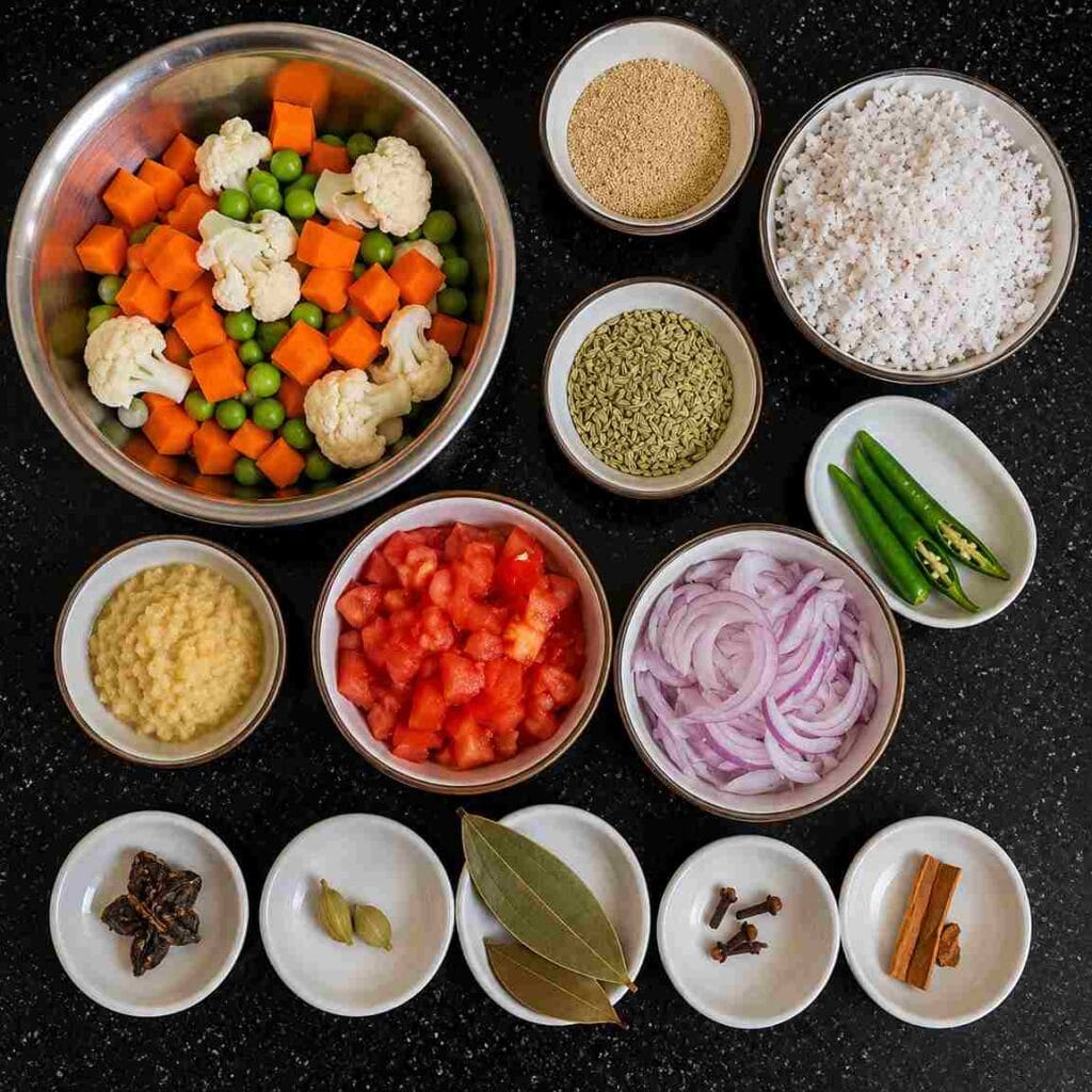 Fresh vegetables, coconut, fennel seeds, spices, onion, tomato, and ginger garlic paste arranged for vegetable kurma recipe