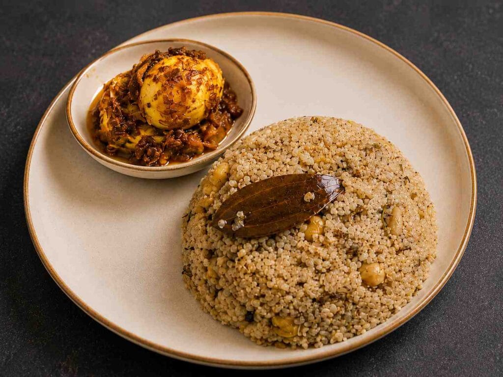 Chickpea Millet Pulao served with egg pickle on a plate