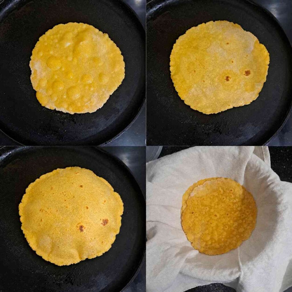 Soft makki atta roti cooking on a hot tawa until golden spots appear