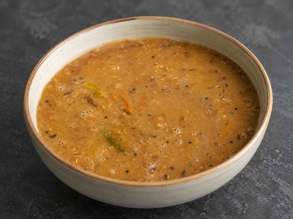 Bowl of traditional Kollu Kadayal made with horse gram, onion, tomato and garlic served hot