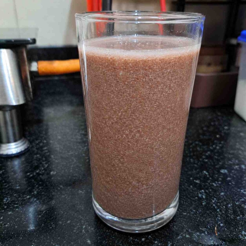 A glass of homemade Kullakar Rice Kanji prepared using traditional Kullakar rice and served as a healthy breakfast.