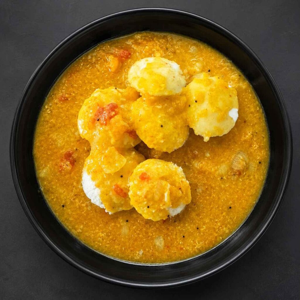 Homemade Parangikkai Sambar served with soft idli for a comforting South Indian breakfast.