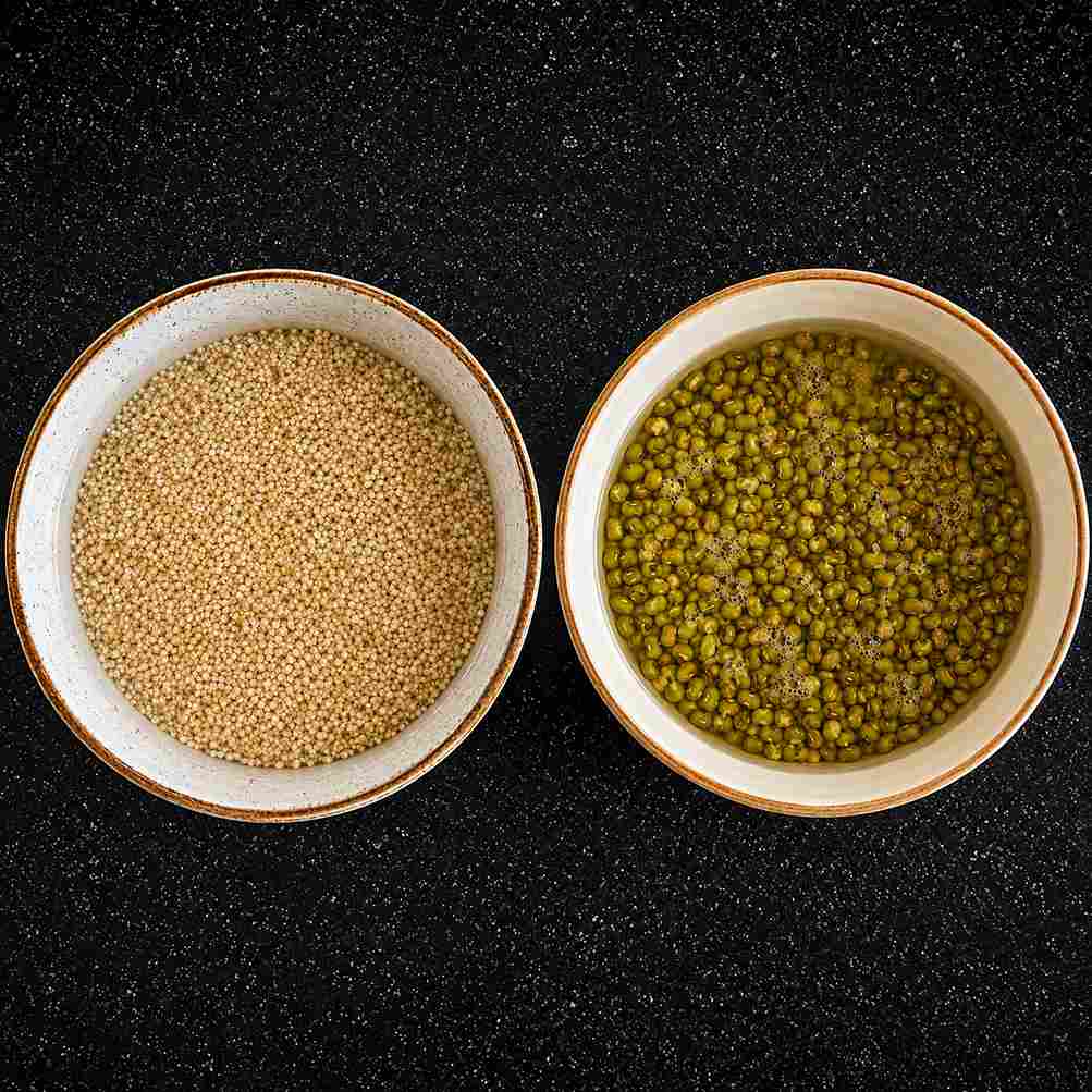 Soaked kodo millet and pacha payaru in bowls, prepared for making healthy millet pulao recipe.