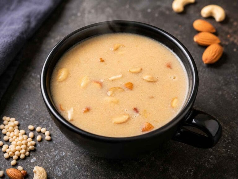 A bowl of traditional Ulundu Paal made with urad dal, country jaggery, coconut milk, and roasted nuts, served warm as a healthy South Indian breakfast.