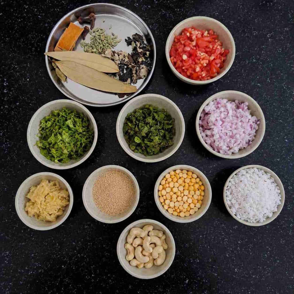 Ingredients for Pressure Cooker Parotta Salna including onions, tomatoes, coconut, mint, coriander, whole spices, cashews, and ginger garlic paste.
