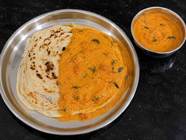 Pressure Cooker Parotta Salna served with flaky parotta, featuring a rich, aromatic hotel-style gravy ready to enjoy.