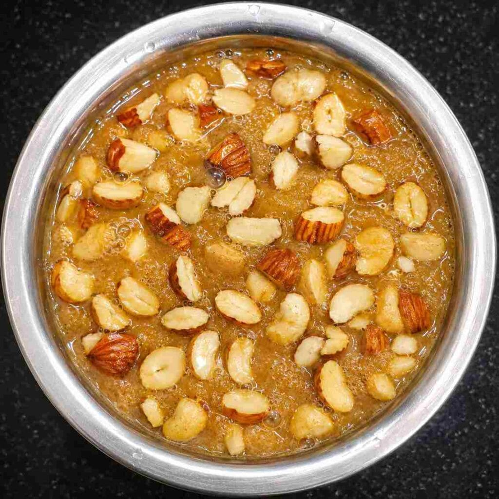 Traditional Ulundu Paal Recipe topped with roasted cashews, almonds, and raisins in ghee before serving.