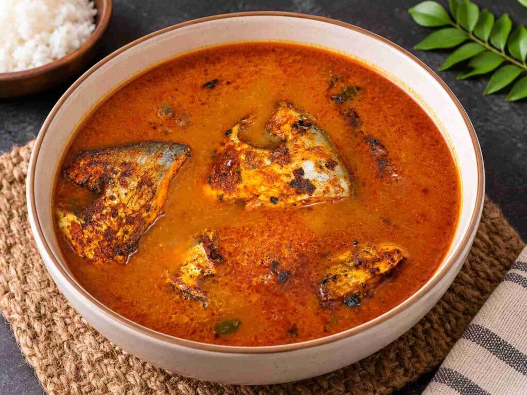 Pomfret fish pieces served in a red tamarind curry with curry leaves