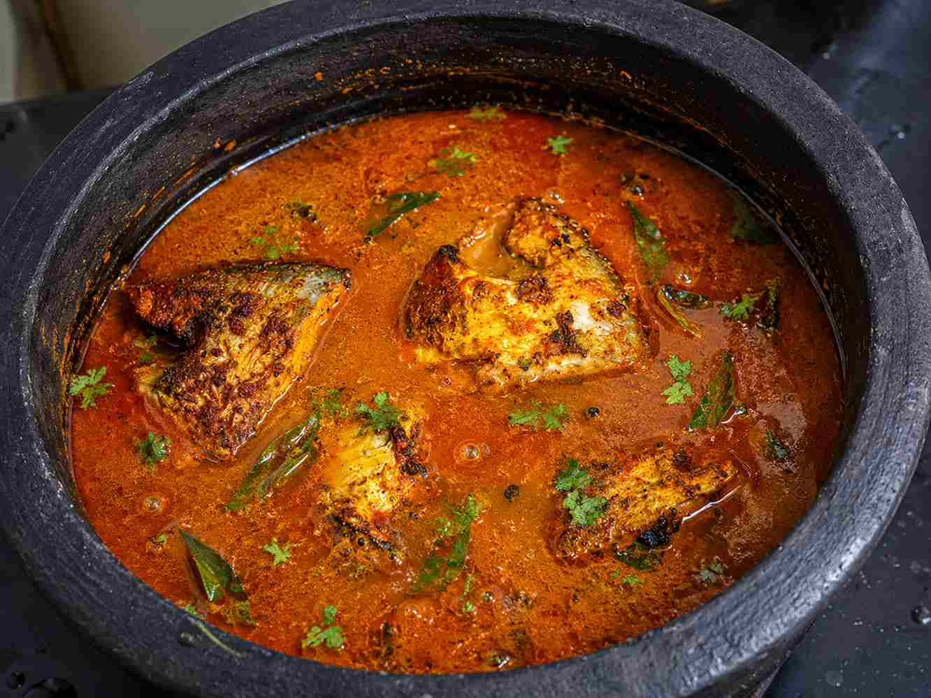Vavval Meen Kulambu with fried pomfret pieces in spicy red gravy